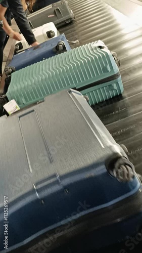 Valise sur le tapis transporteur à bagages dans la zone de retrait des bagages d'un terminal de l'aéroport photo