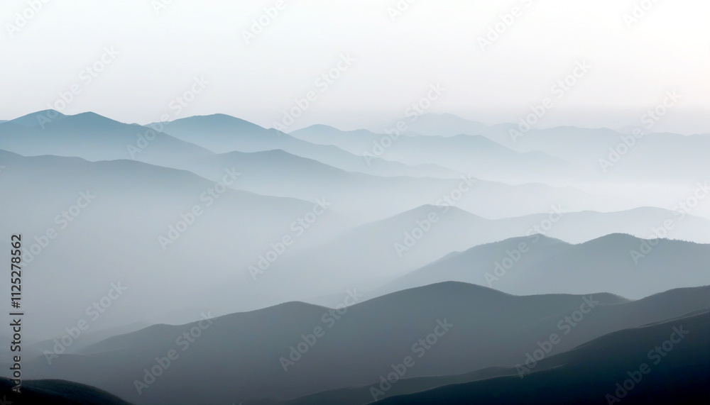 Majestic layers of mountains enveloped in soft, gentle mist at dawn Majestic layers of mountains enveloped in soft, gentle mist at dawn