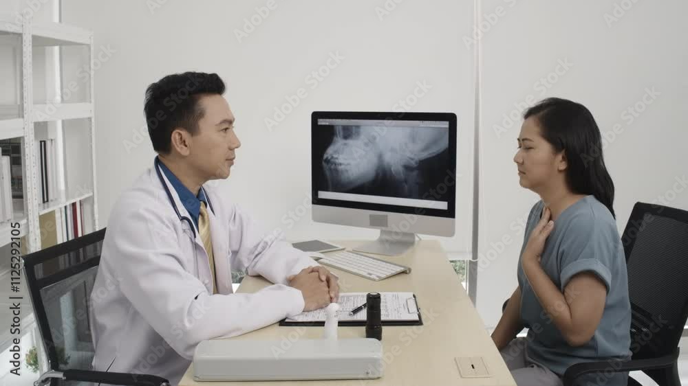 A smart male doctor is talking while explaining medical treatment to the patient in the consultation.