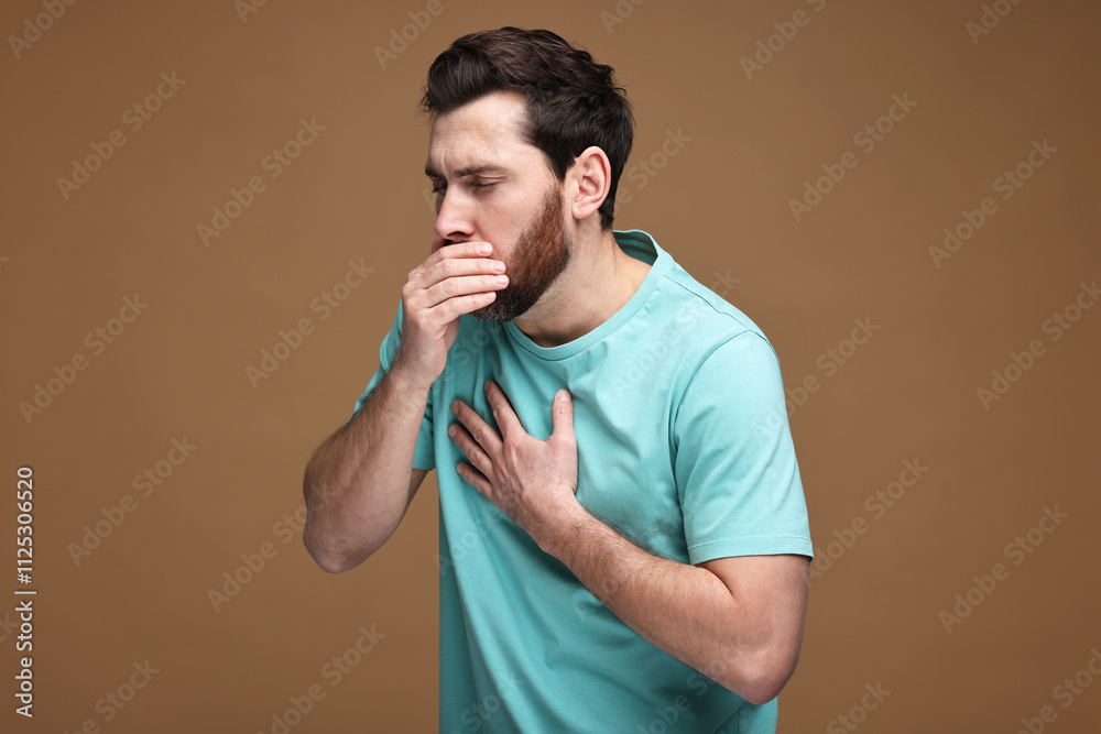 Sick man coughing on brown background. Cold symptoms Sick man coughing on brown background. Cold symptoms