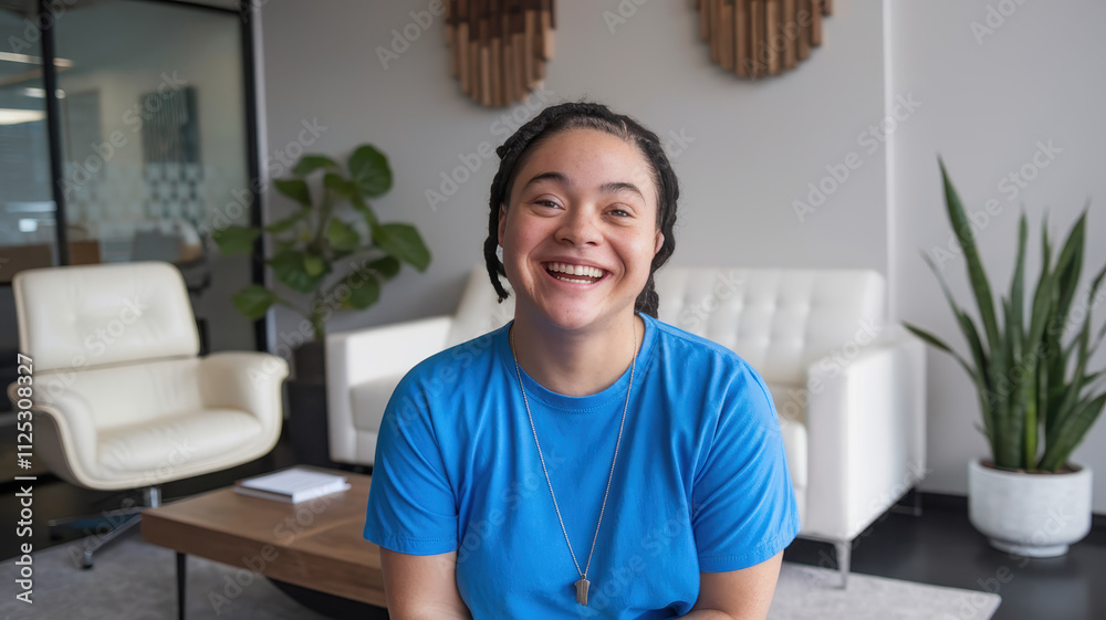 Cheerful young woman with braided hair in a blue shirt, sitting in a modern office space, exuding positivity and warmth. Cheerful young woman with braided hair in a blue shirt, sitting in a modern office space, exuding positivity and warmth.