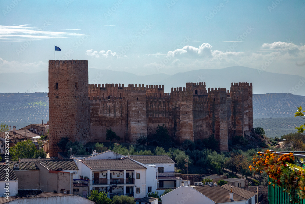 Obraz premium Spectacular full view of the walls and turrets of the medieval castle of Burgalimar in Baños de la Encina, Jaén, Andalusia, Spain with evening light