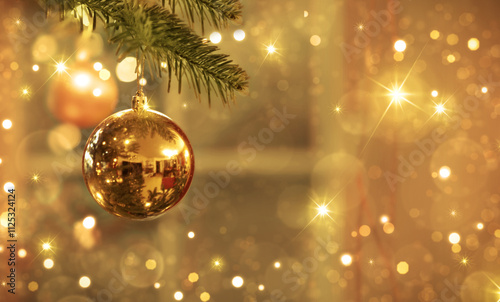 Golden Christmas ball on fir tree branch isolated on blur background.