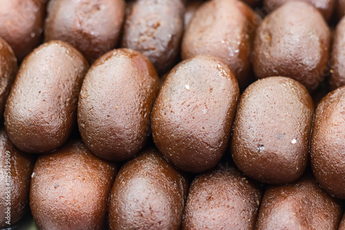 Kalojam or Kalo Jam texture closeup side view of Indian, pakistani and bangladeshi sweet dessert food photo