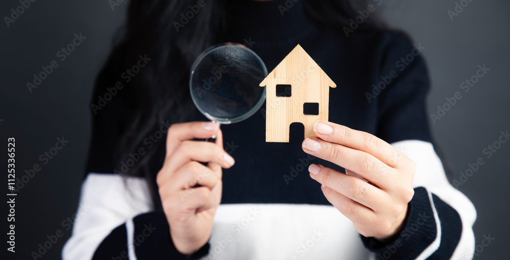 woman looking at the house with a magnifying glass woman looking at the house with a magnifying glass