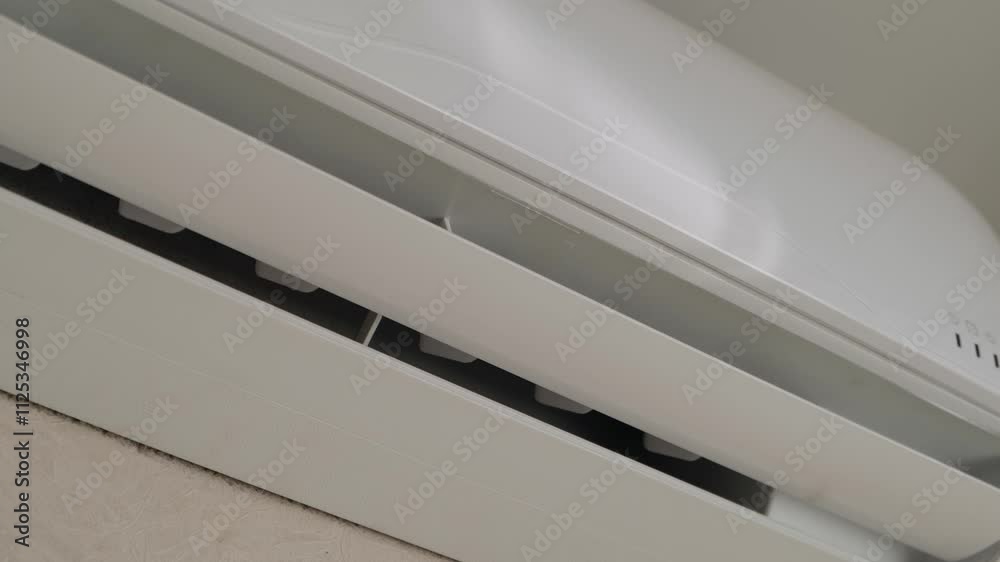 Opening the air conditioner curtain when turned on, close-up Opening the air conditioner curtain when turned on, close-up