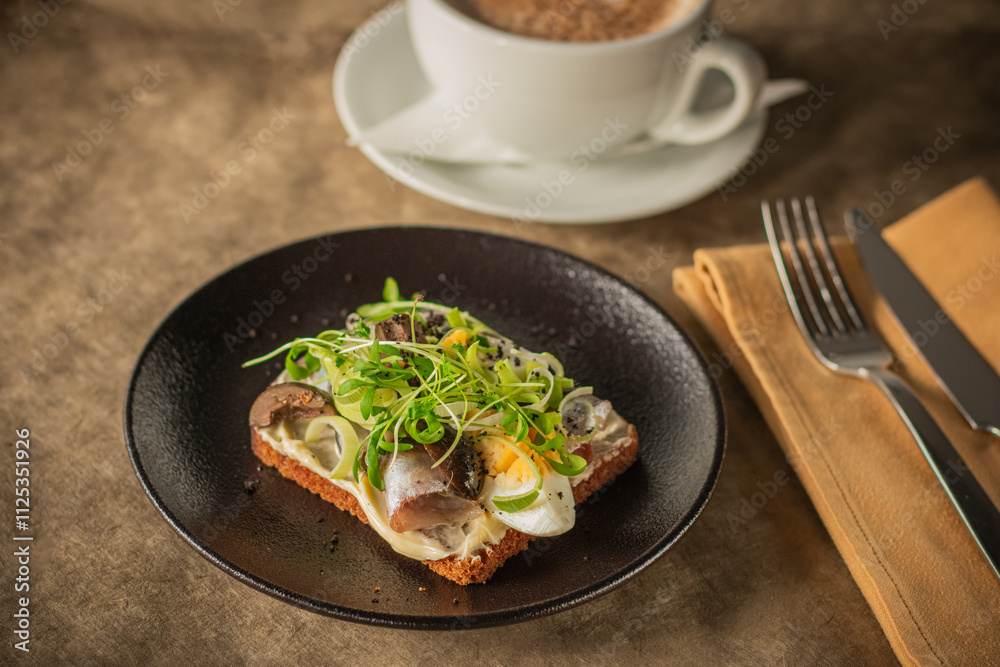 Close-up of a rustic toast topped with herring, boiled egg, greens Close-up of a rustic toast topped with herring, boiled egg, greens