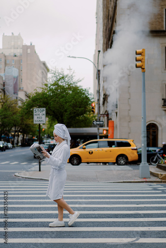 Urban Elegance Woman Engrossed in Reading While Wearing a Comforting Hotel Robe