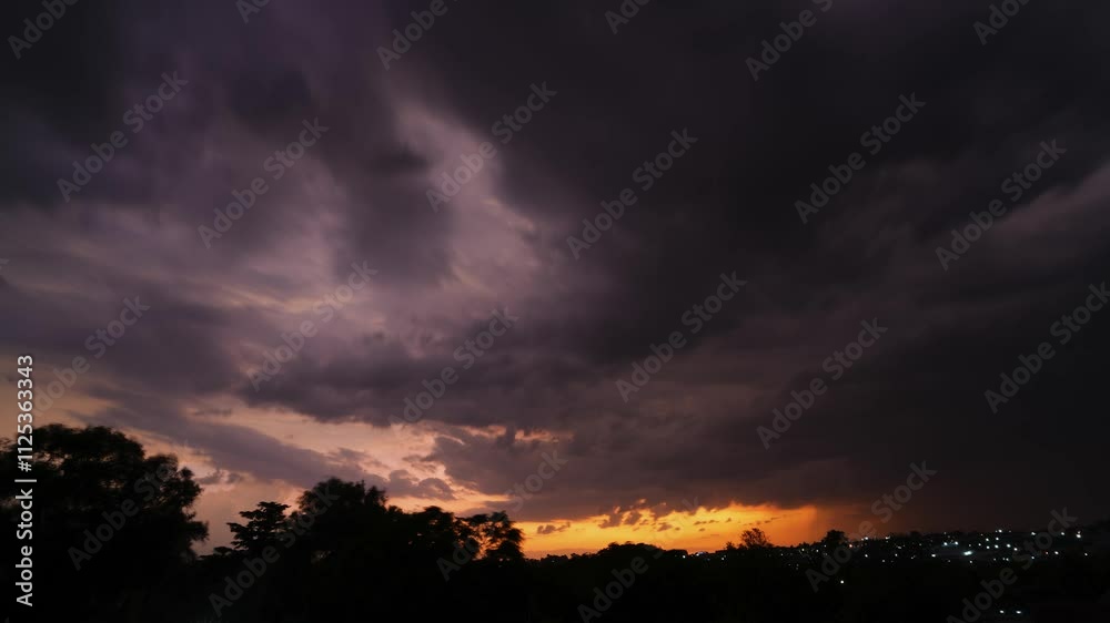 A 4K High Res timelapse of a storm over a suburban area, with dramatic lightning strikes illuminating the vibrant sunset hues of orange and pink against a shifting sky A 4K High Res timelapse of a storm over a suburban area, with dramatic lightning strikes illuminating the vibrant sunset hues of orange and pink against a shifting sky