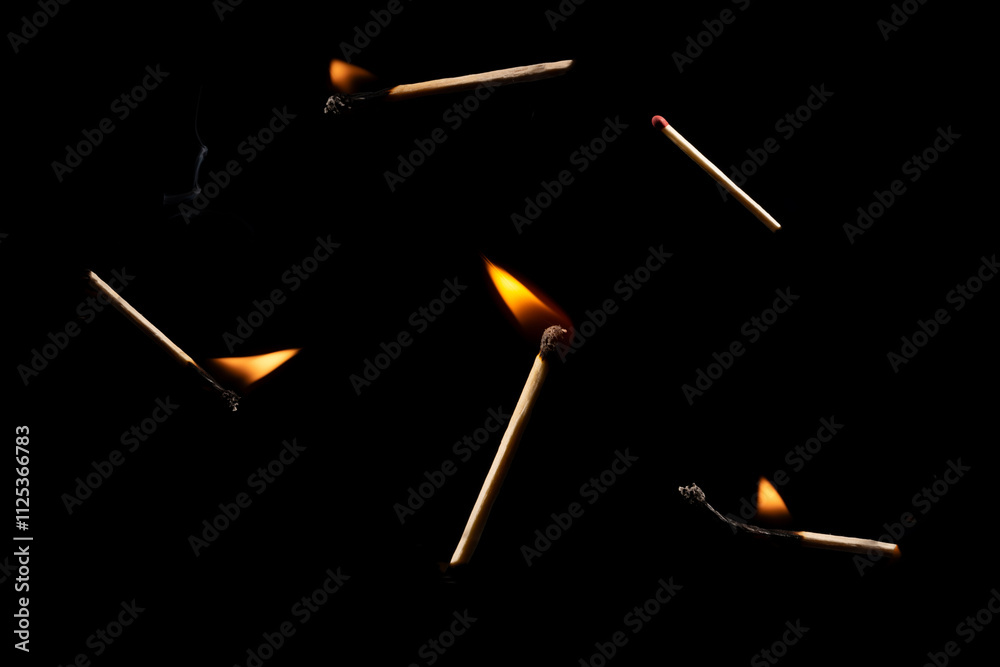 Lit falling match on a black background. Lit falling match on a black background.