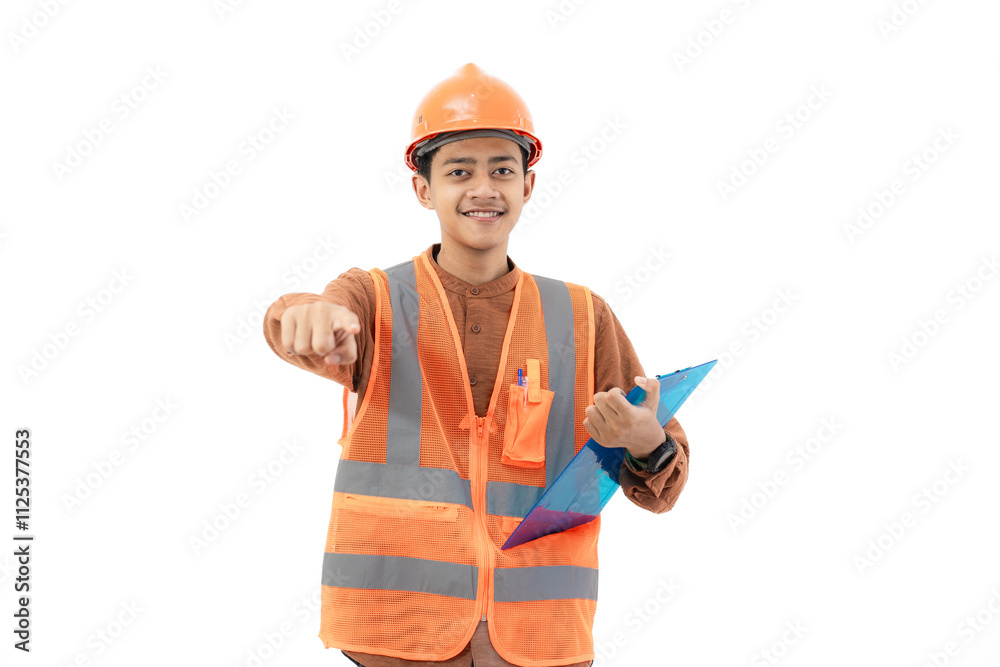Young Indonesian male construction worker in full safety gear standing and pointing to the side, construction and industry concept, isolated on white background. Young Indonesian male construction worker in full safety gear standing and pointing to the side, construction and industry concept, isolated on white background.