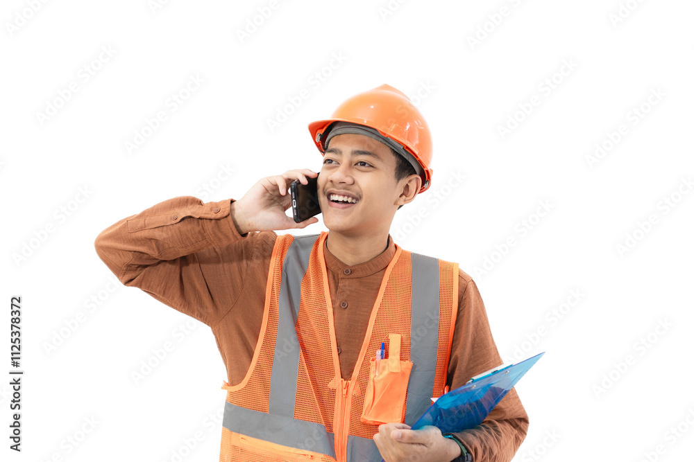 Young Indonesian male construction worker in full safety gear is on a voice call with his co-worker while holding a clipboard, construction and industry concept, isolated on white background. Young Indonesian male construction worker in full safety gear is on a voice call with his co-worker while holding a clipboard, construction and industry concept, isolated on white background.