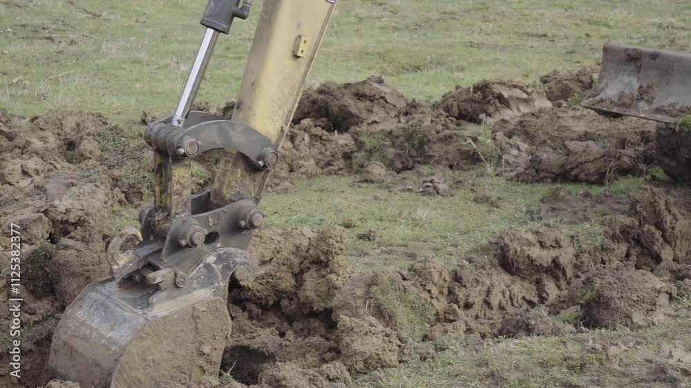 Small excavator is digging mud. Small excavator is digging mud.