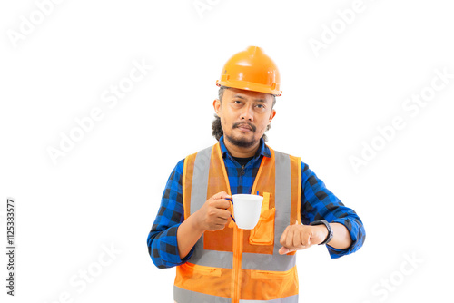 Indonesian male construction worker in full safety gear looking at time on his watch while enjoying a cup of coffee while working, construction and industry concept, isolated on white background.