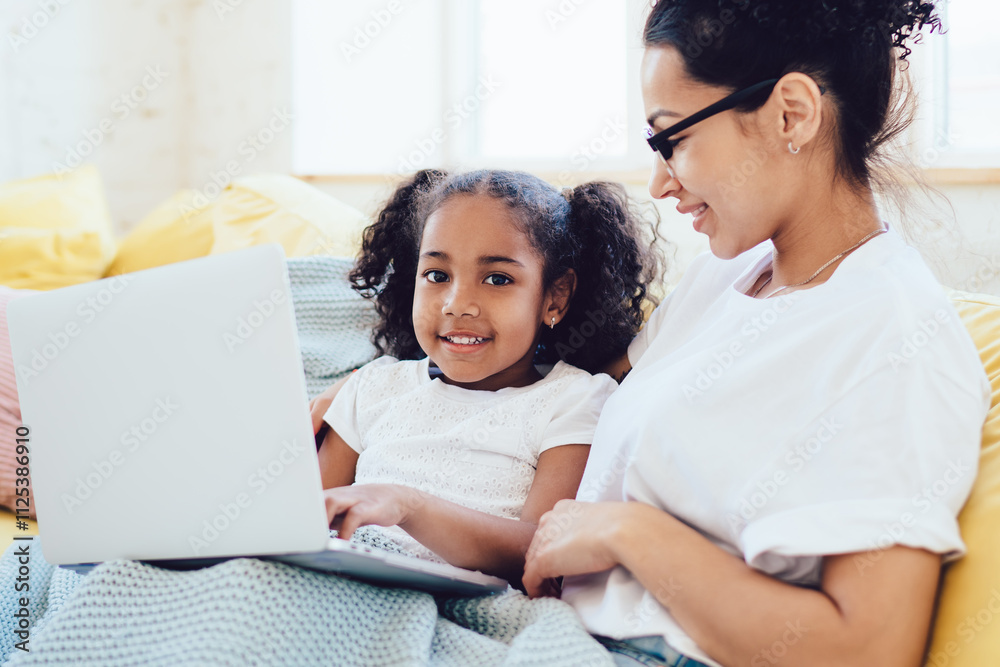 Ethnic parent and kid watching film Ethnic parent and kid watching film