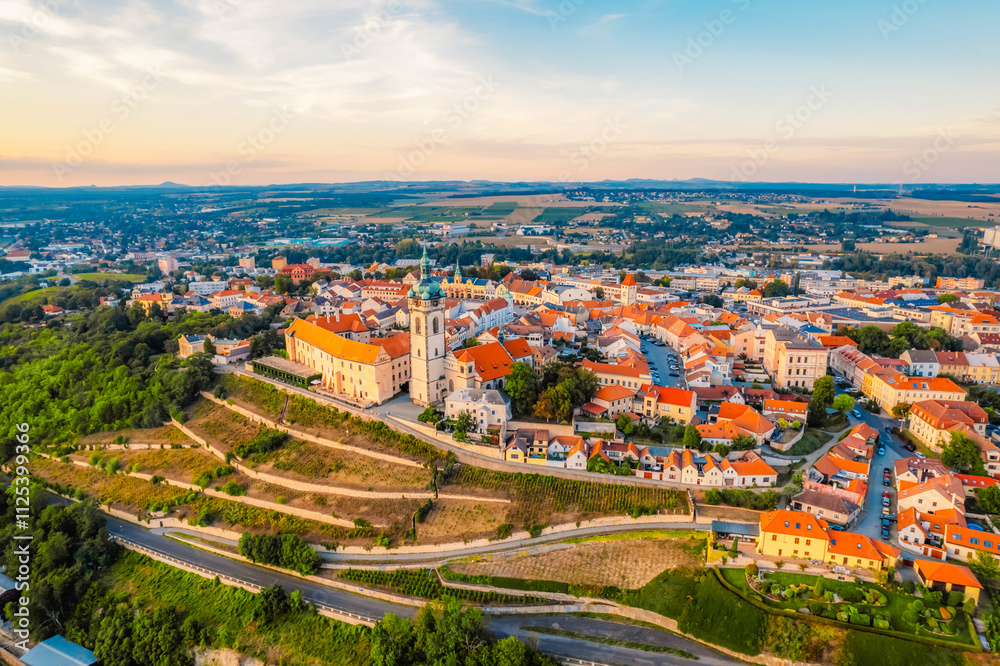 Fototapeta premium Melnik Castle on the hill above Labe and Vltava River in sunny day. Church with city space and square. Czech Republic.