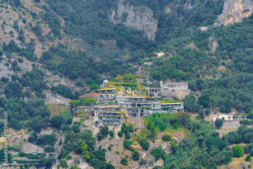 A beautifully integrated estate on a mountain slope covered with vegetation photo