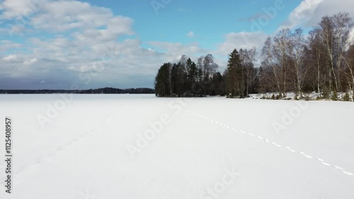 Wallpaper Mural Forward ascending drone flight over snowy ice covered lake in Vehmaanniemi, Sastamala, Finland Torontodigital.ca