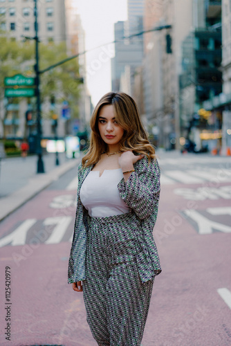 Woman walking in urban city street wearing stylish checkered suit