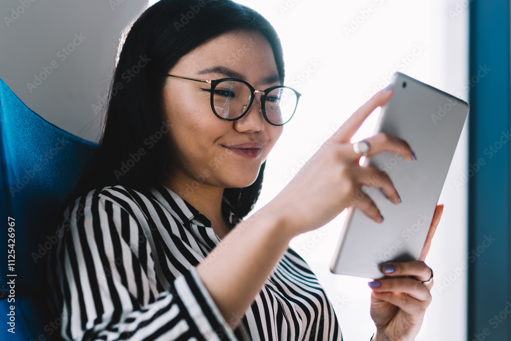 Smiling Asian woman using tablet Smiling Asian woman using tablet
