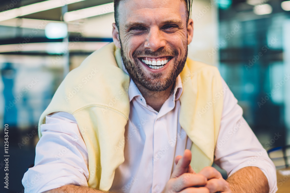 Obraz premium Portrait of cheerful businessman sitting at desk with money wat and laughing at camera enjoying rich lifestyle, Caucasian male entrepreneur in smart casual clothing satisfied with revenue