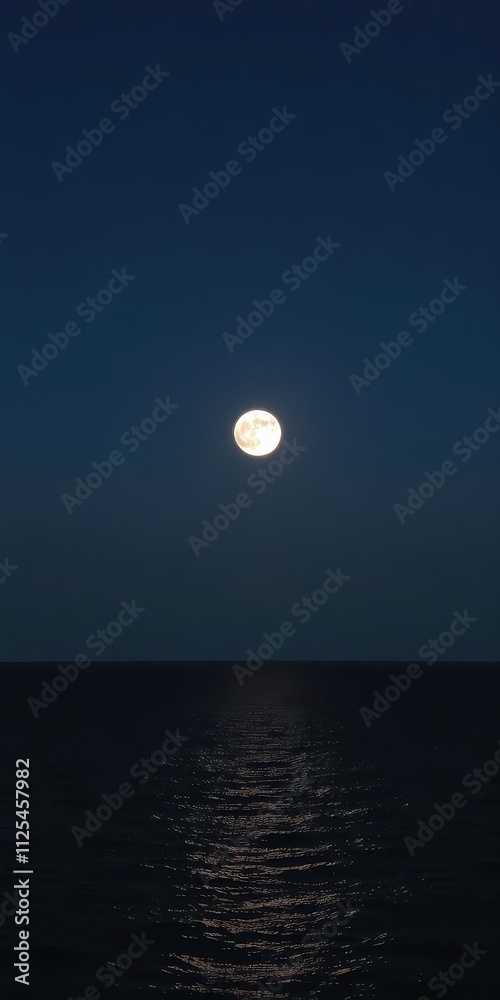 Full moon rising over serene ocean at night with clear sky and copy space, Full moon Full moon rising over serene ocean at night with clear sky and copy space, Full moon