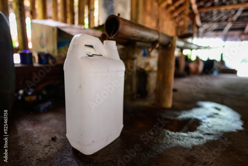 Arak Distillery Interior with Liquor Dripping into Can from a Bamboo Pipe in Flores, Indonesia