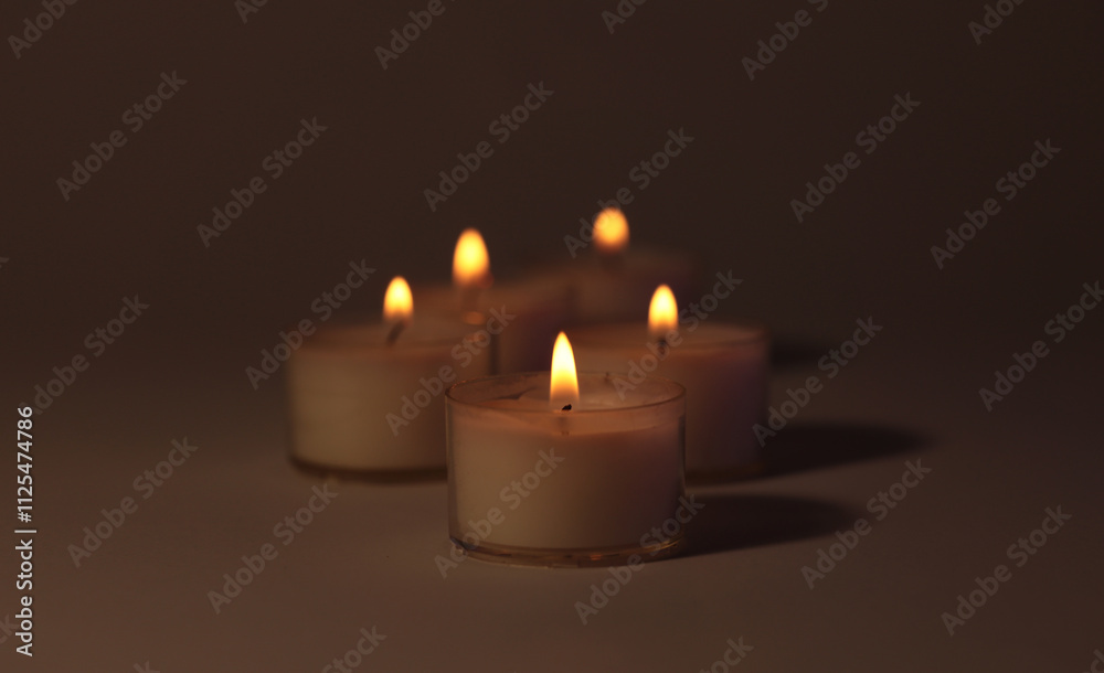 Soft focus. blur Burning candles in dark. Evening Light and shadow background. Minimalist still life.