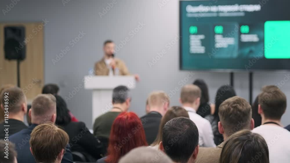 custom made wallpaper toronto digitalAudience at business conference focused on speaker's presentation. Engaged attendees listening attentively.