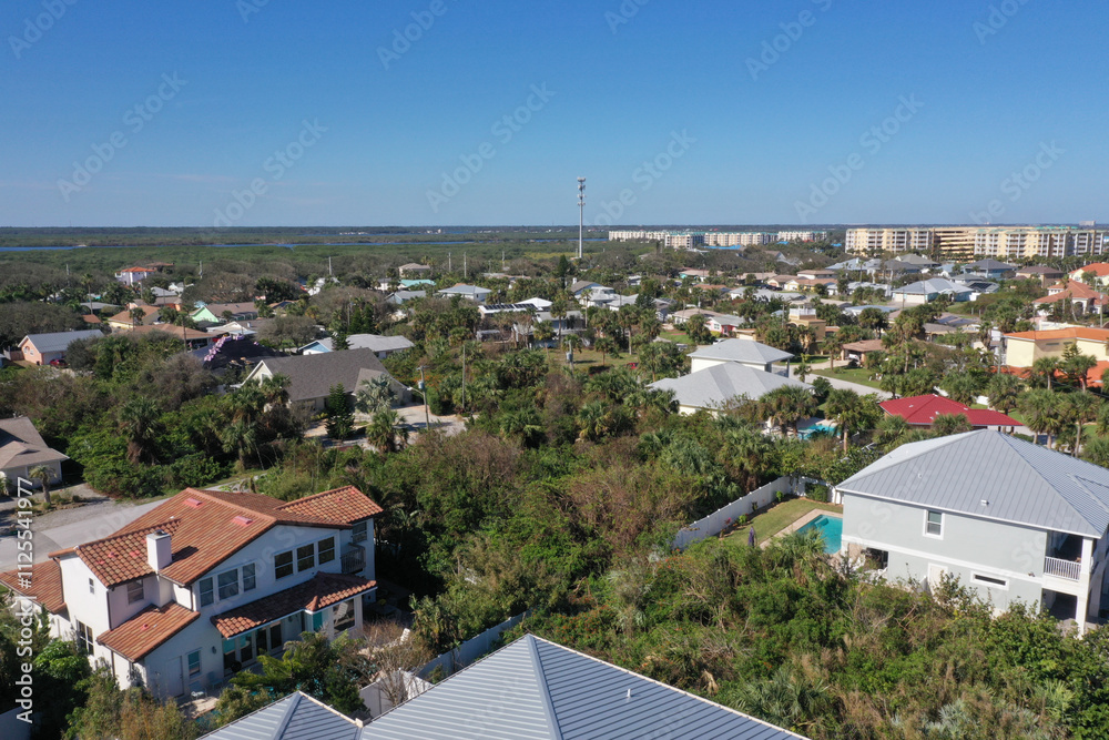 Aerial looking north over New Smyrna Beach, Florida towards Ponce Inlet , Florida neighborhoods, beachfront hotels and condos and the Atlantic Ocean. Aerial looking north over New Smyrna Beach, Florida towards Ponce Inlet , Florida neighborhoods, beachfront hotels and condos and the Atlantic Ocean.