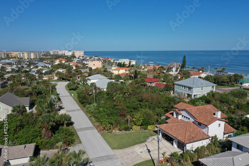 Aerial looking north over New Smyrna Beach, Florida towards Ponce Inlet , Florida neighborhoods, beachfront hotels and condos and the Atlantic Ocean.