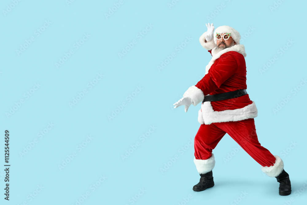 Funny Santa Claus dancing on blue background Funny Santa Claus dancing on blue background