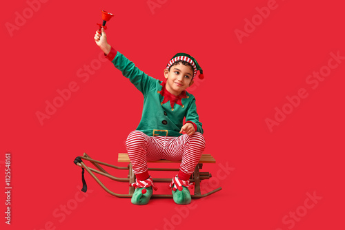 Cute little elf with sled a...