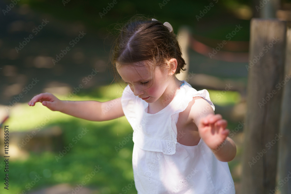 Little cute girl without front tooth rope playground summer park. Concept of active healthy cheerful child Little cute girl without front tooth rope playground summer park. Concept of active healthy cheerful child