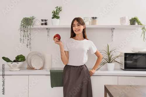 Young woman with apple near...
