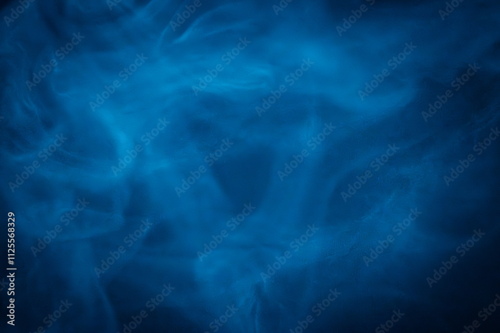 A close-up of soft, swirling blue smoke patterns creating an ethereal and dreamy abstract effect against a dark background A close-up of soft, swirling blue smoke patterns creating an ethereal and dreamy abstract effect against a dark background