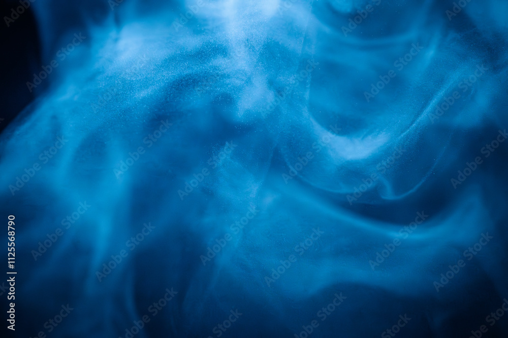 Fototapeta premium A close-up of soft, swirling blue smoke patterns creating an ethereal and dreamy abstract effect against a dark background