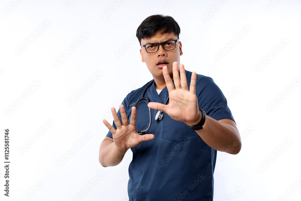 © ArvStd - Healthcare workers concept. Serious-looking displeased asian doctor, nurse in scrubs stopping you, show prohibit, warning gesture, forbid patient
