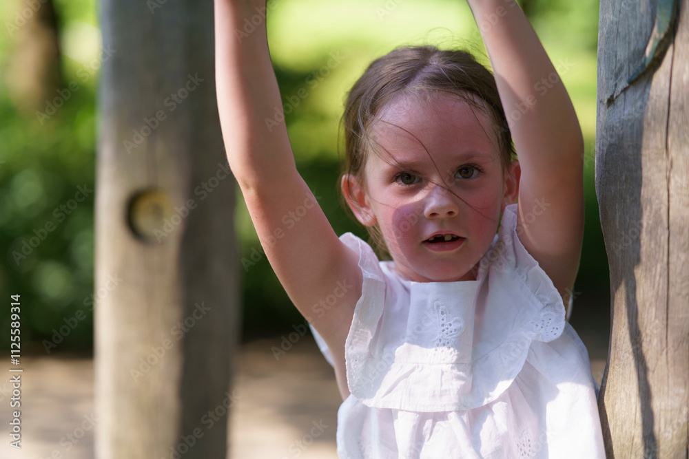 Little cute girl without front tooth rope playground summer park. Concept of active healthy cheerful child Little cute girl without front tooth rope playground summer park. Concept of active healthy cheerful child