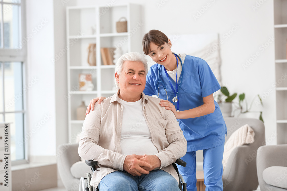 Female doctor hugging mature man in wheelchair at home Female doctor hugging mature man in wheelchair at home