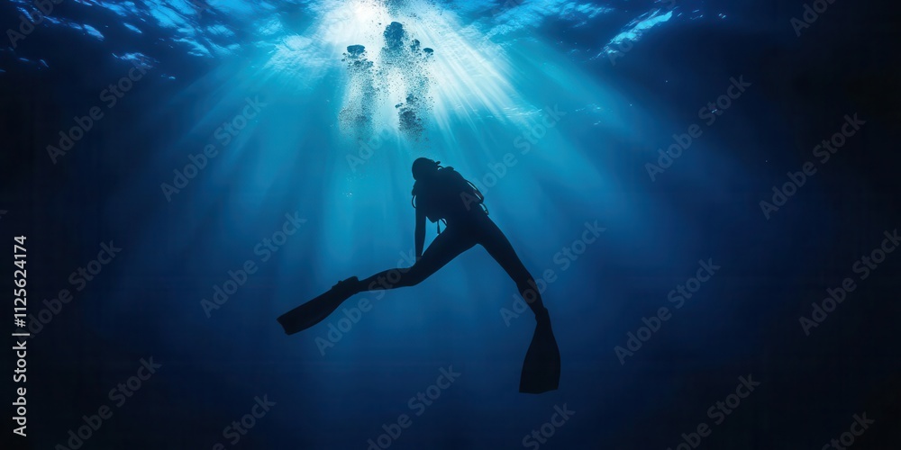 A diver exploring the serene underwater world illuminated by beams of light. A diver exploring the serene underwater world illuminated by beams of light.