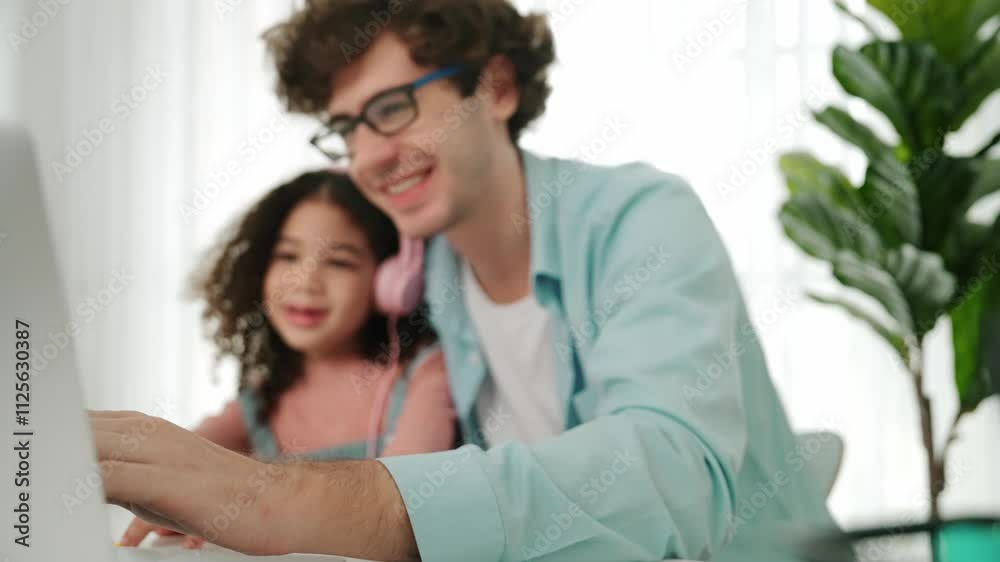 Caucasian dad teaching american daughter with headphone writing engineering code. Smart cute american daughter looking at computer screen while learning about generate AI with happy father. Pedagogy. Caucasian dad teaching american daughter with headphone writing engineering code. Smart cute american daughter looking at computer screen while learning about generate AI with happy father. Pedagogy.