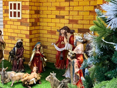 Christmas nativity scene with family. Christmas Manger scene with figurines including Jesus, Mary, Joseph, sheep and magi.