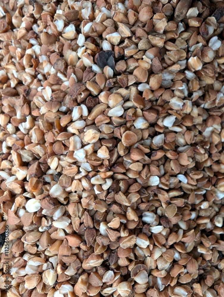 Raw buckwheat texture. Background of buckwheat groats Raw buckwheat texture. Background of buckwheat groats