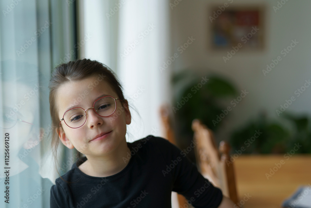 little cute girl with glasses standing near big window. Smart conscious child concept little cute girl with glasses standing near big window. Smart conscious child concept