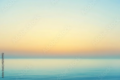 A serene seascape at dawn, showcasing calm waters and a gradient sky.