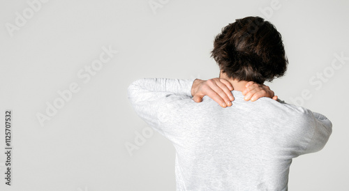 Man holding hand in neck pain area, free space photo