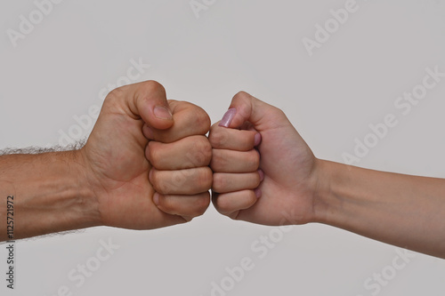 fist to fist, male and female. on a white background.