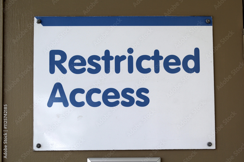 Restricted Access sign attached to a brown door