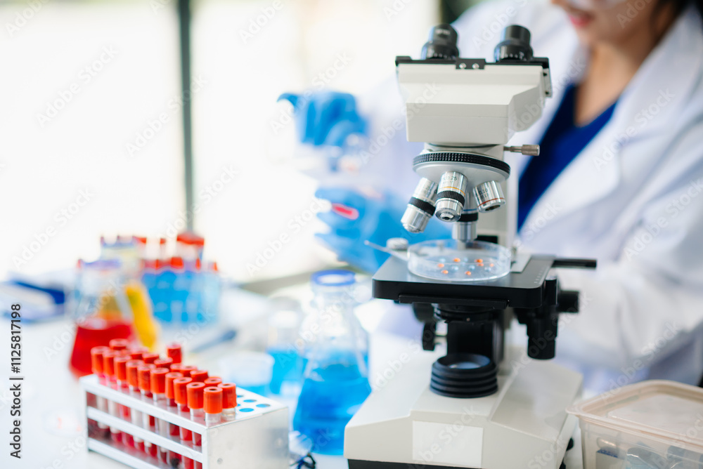 Discover a dedicated scientist conducting laboratory research, using pipettes, microscopes, and lab equipment. Discover a dedicated scientist conducting laboratory research, using pipettes, microscopes, and lab equipment.